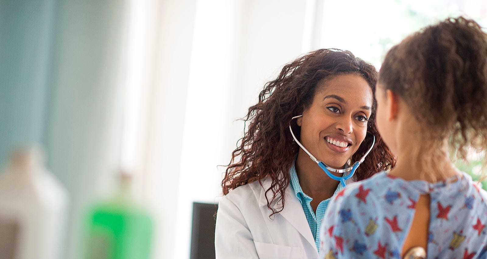 A female doctor examines a young girl