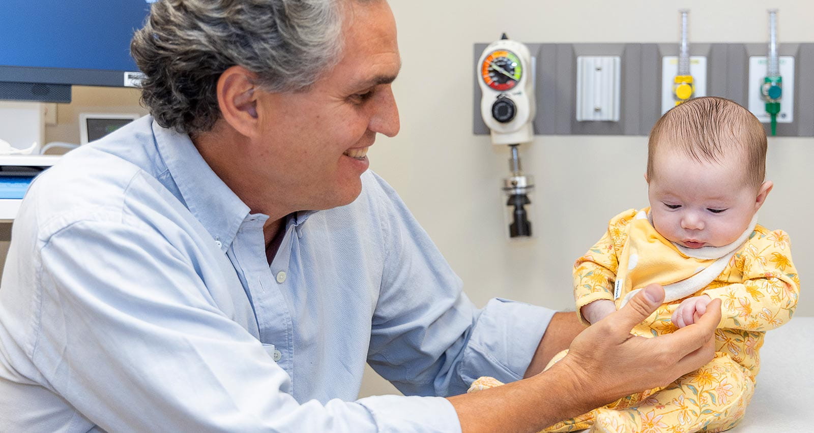 Juan Moldes Larribas, MD holds an infant patient