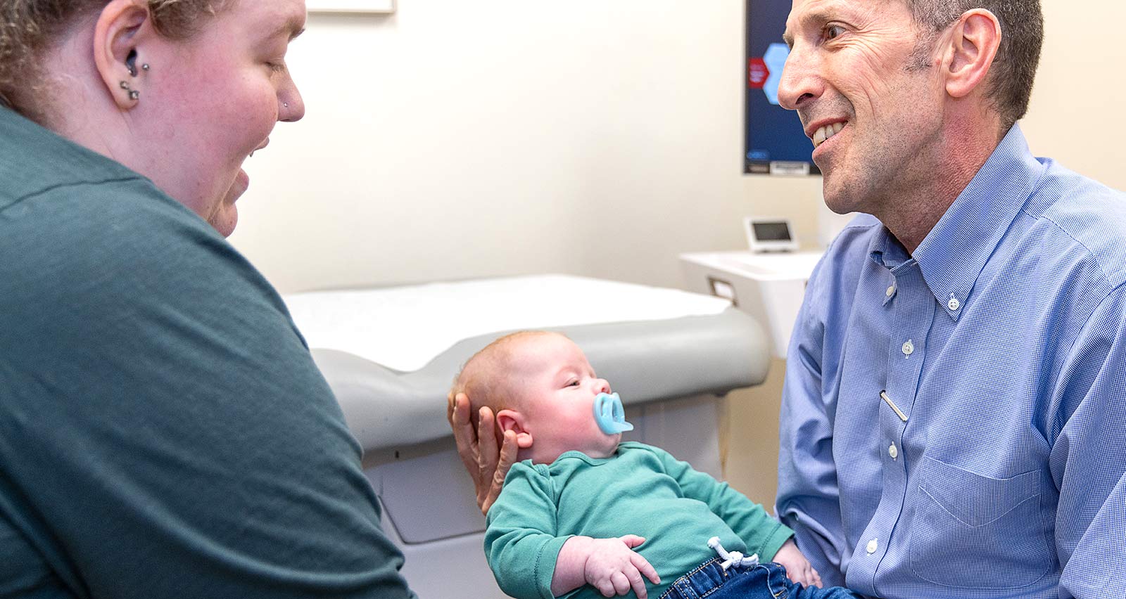 Pedro Jose Lopez, MD holds a young patient