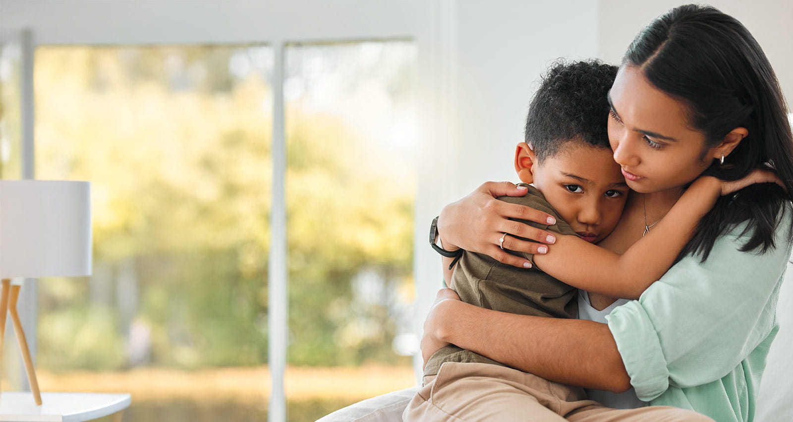 A young mother holds her worried son