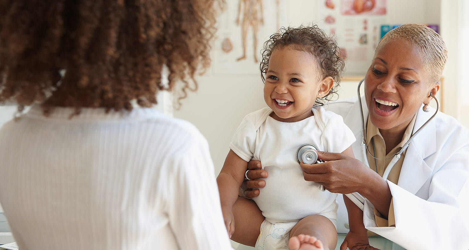 Doctor listening to baby's breathing with stethoscope