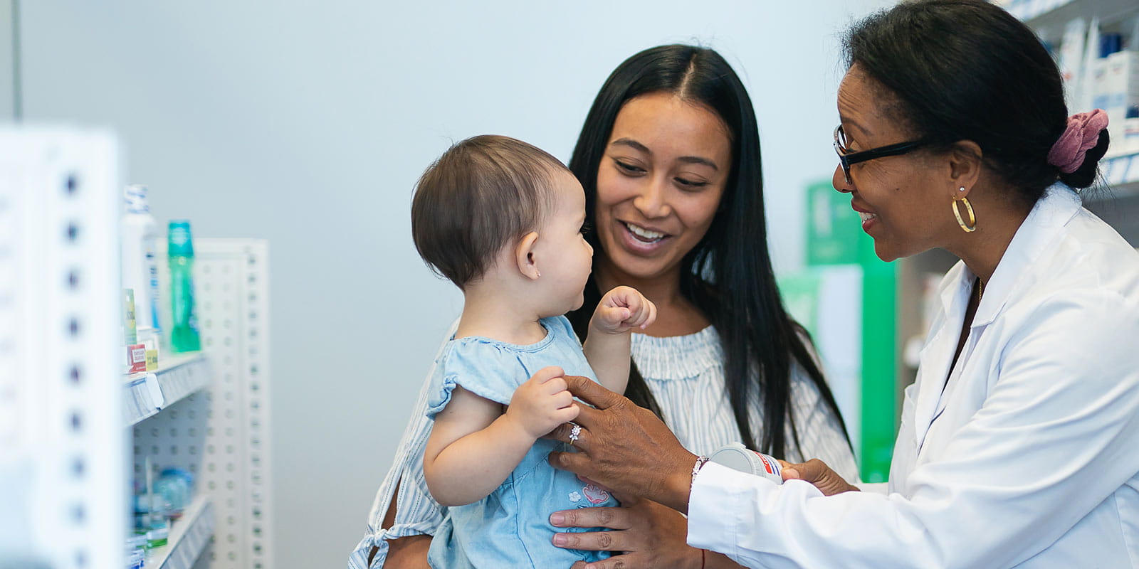 Pharmacist Talking with a Young Mother and Her Daughter