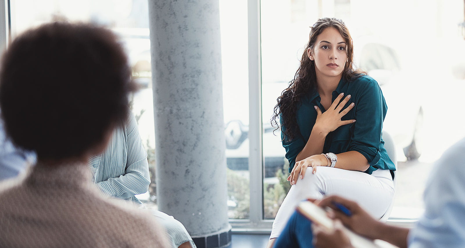 People attending a group therapy session, sharing personal stories, supporting their struggle with addiction