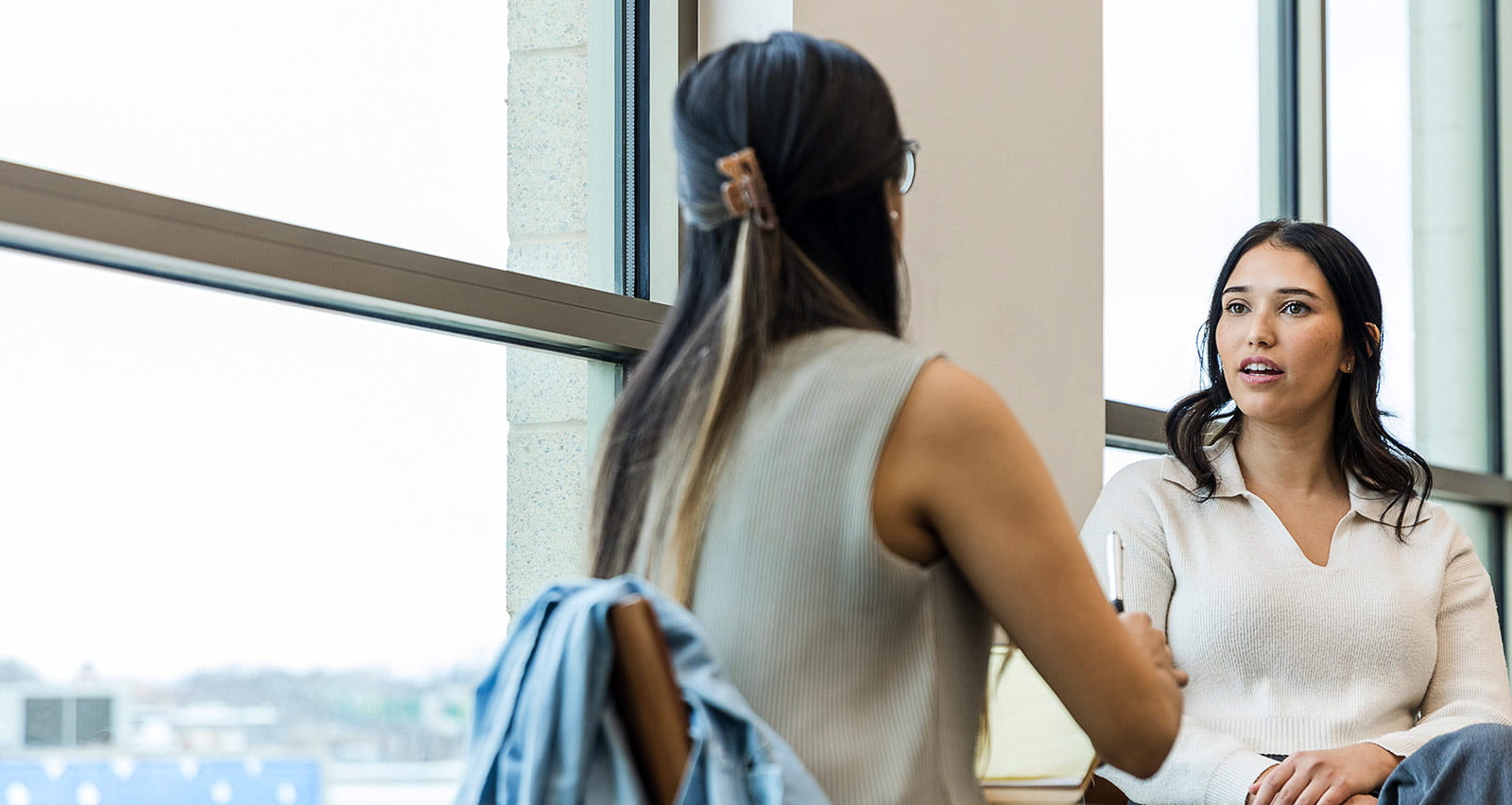 A behavioral health provider in session with a female patient