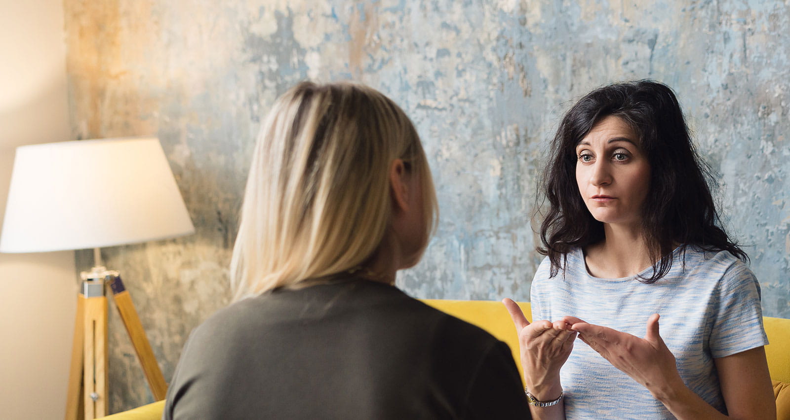Woman psychologist talking to female patient