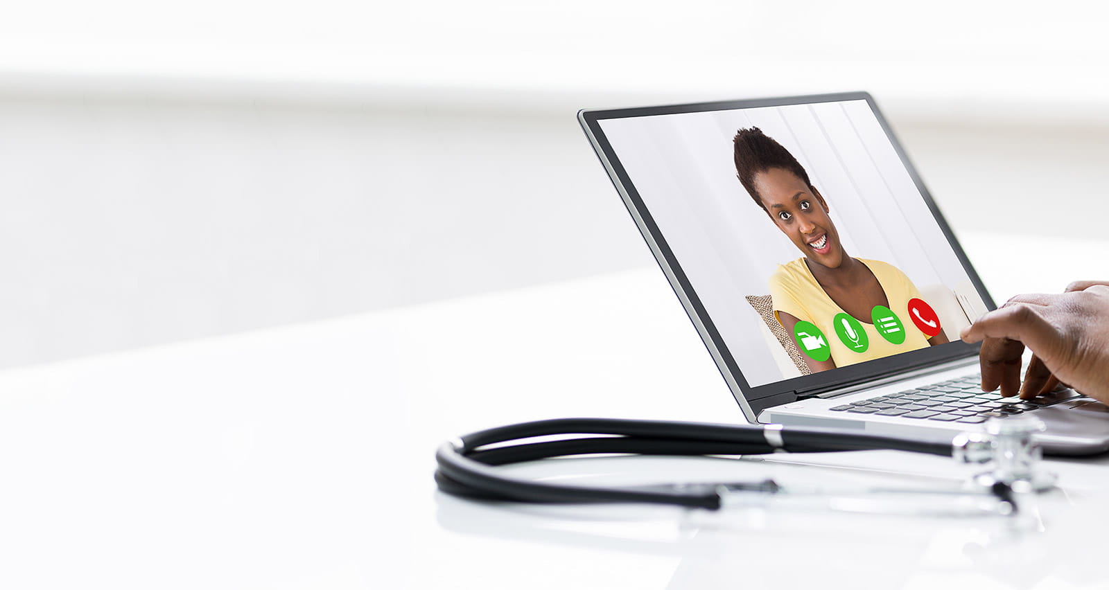Doctor participating in Virtual Office Visit with patient on laptop