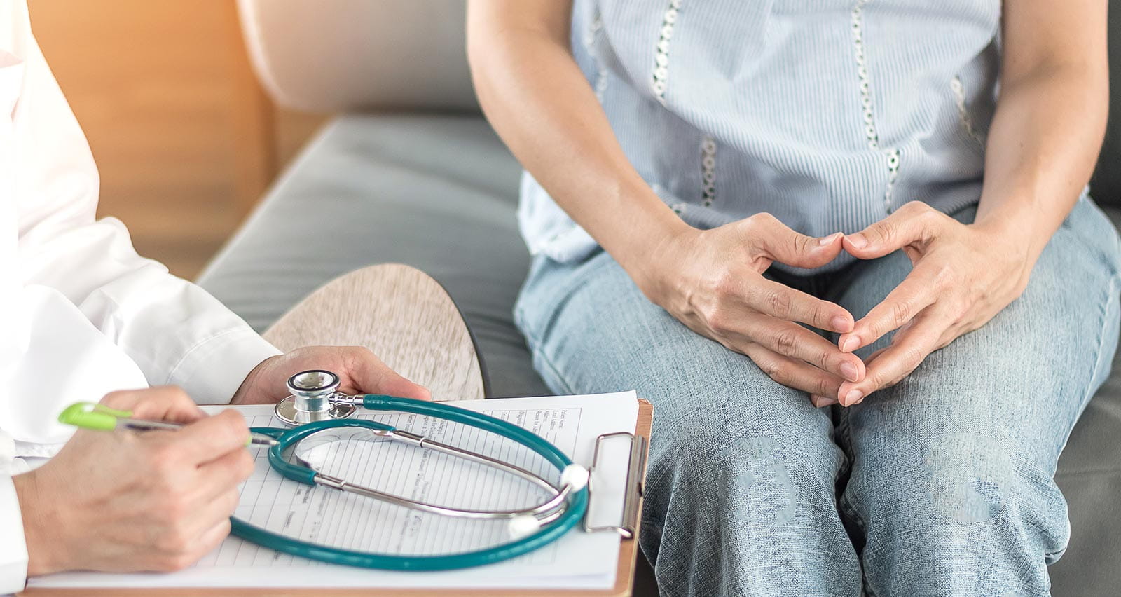 Doctor consulting and diagnostic examining stressful female patient on obstetric / gynecological illness