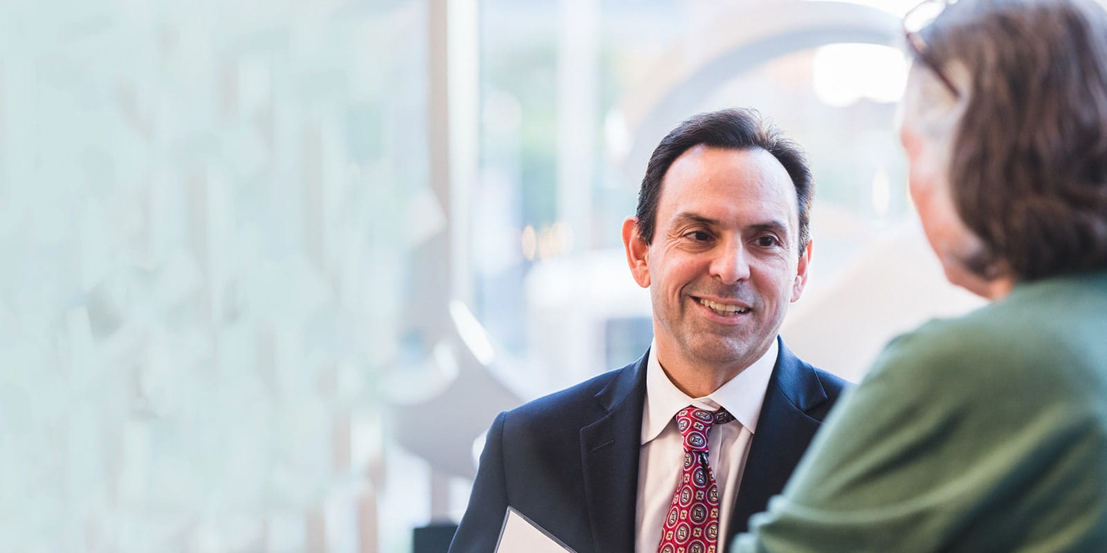 Ted Teknos, MD speaking with female patient.