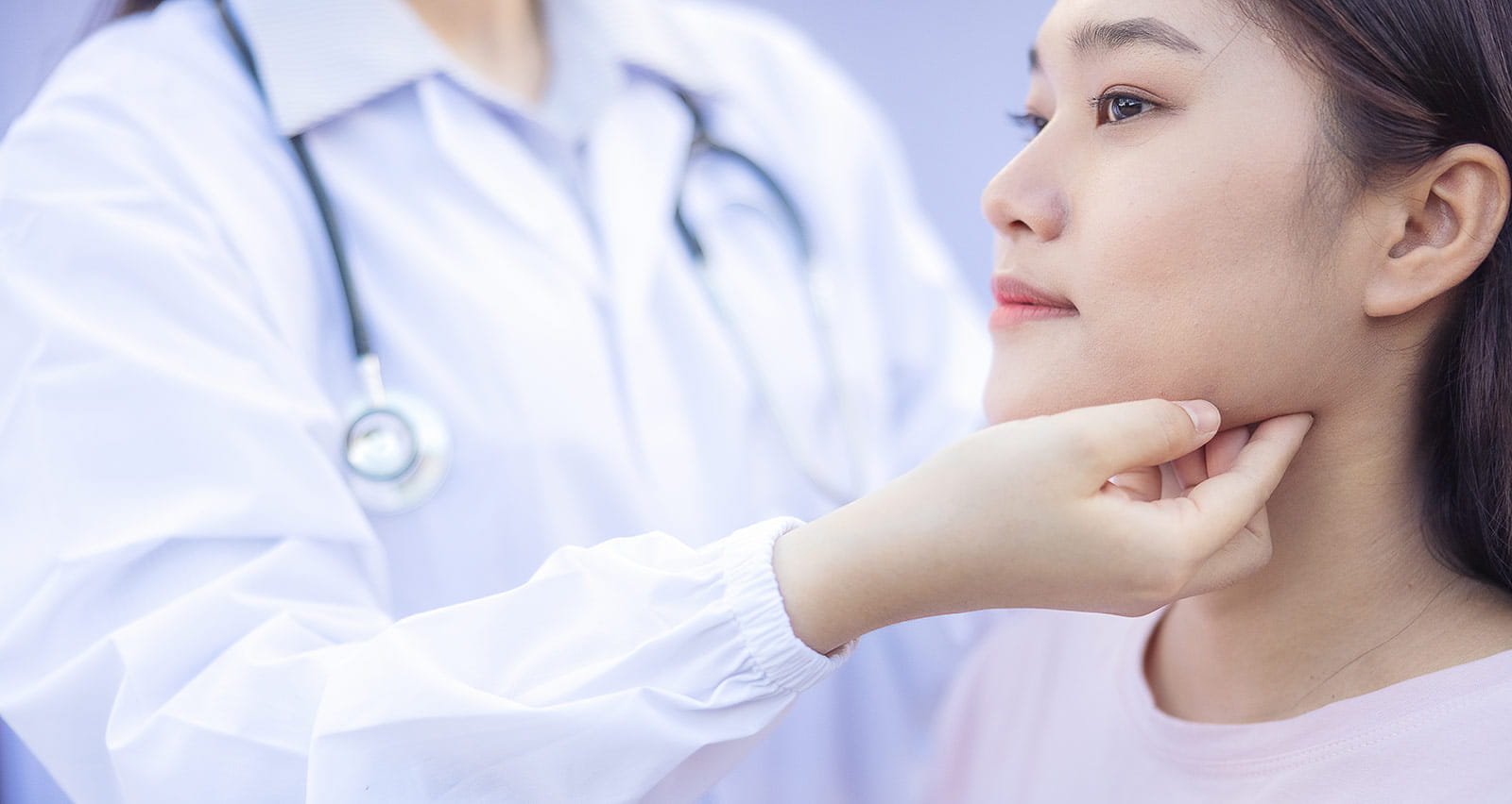 Doctor examines the back and neck of a female patient