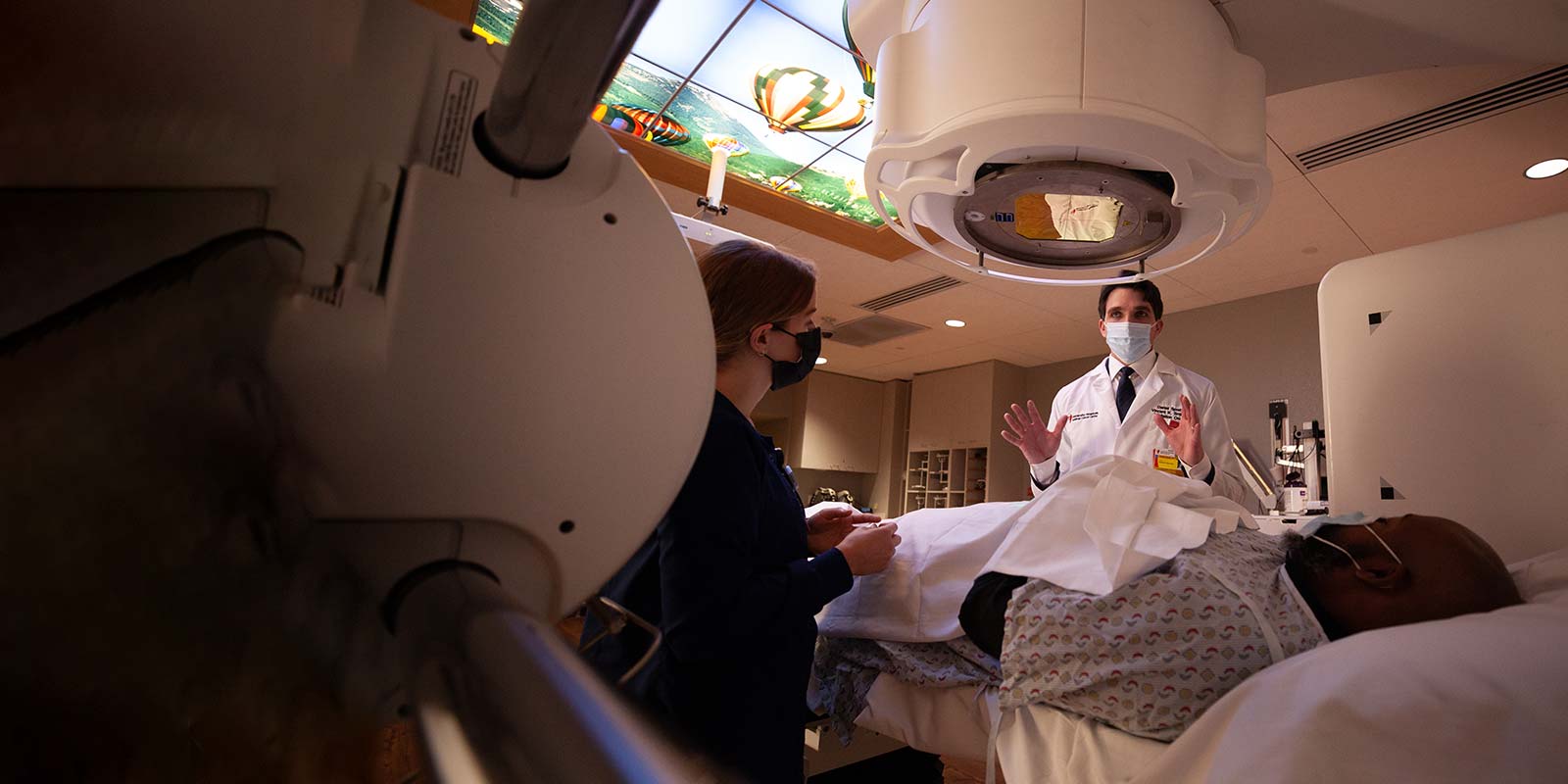 Dr. Spratt with radiation oncology tech and patient performing SBRT