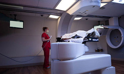 Therapy personnel performing Proton Therapy on patient