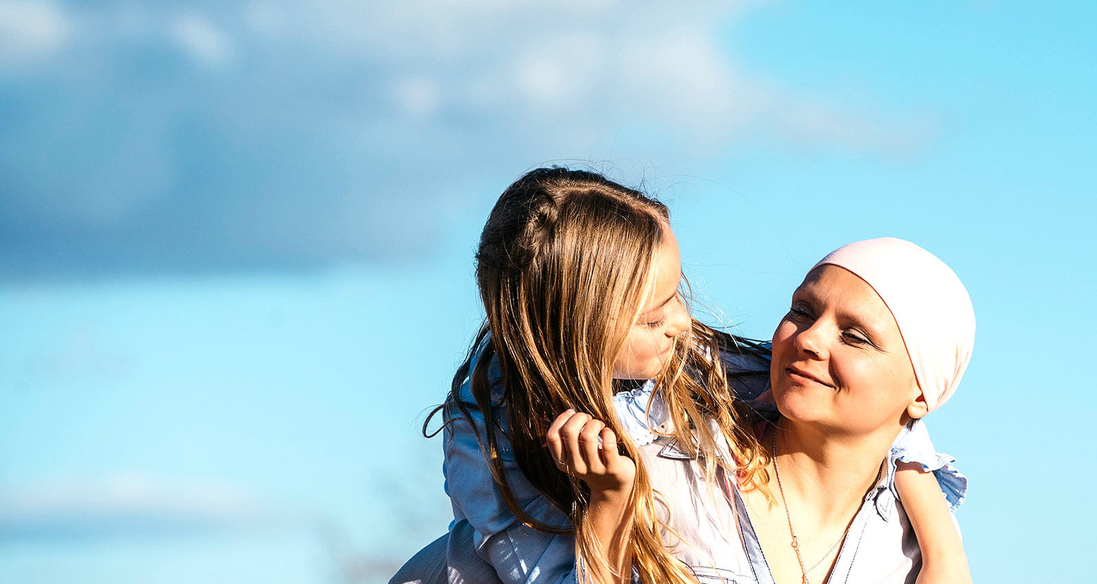 A woman with cancer is next to her daughter