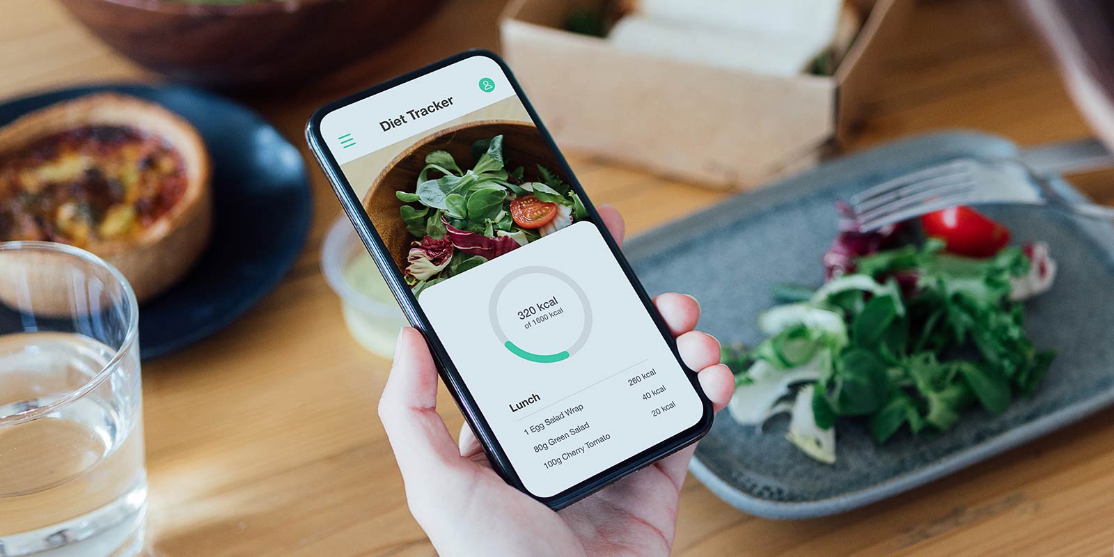 woman using mobile app to track nutrition and count calories with smartphone