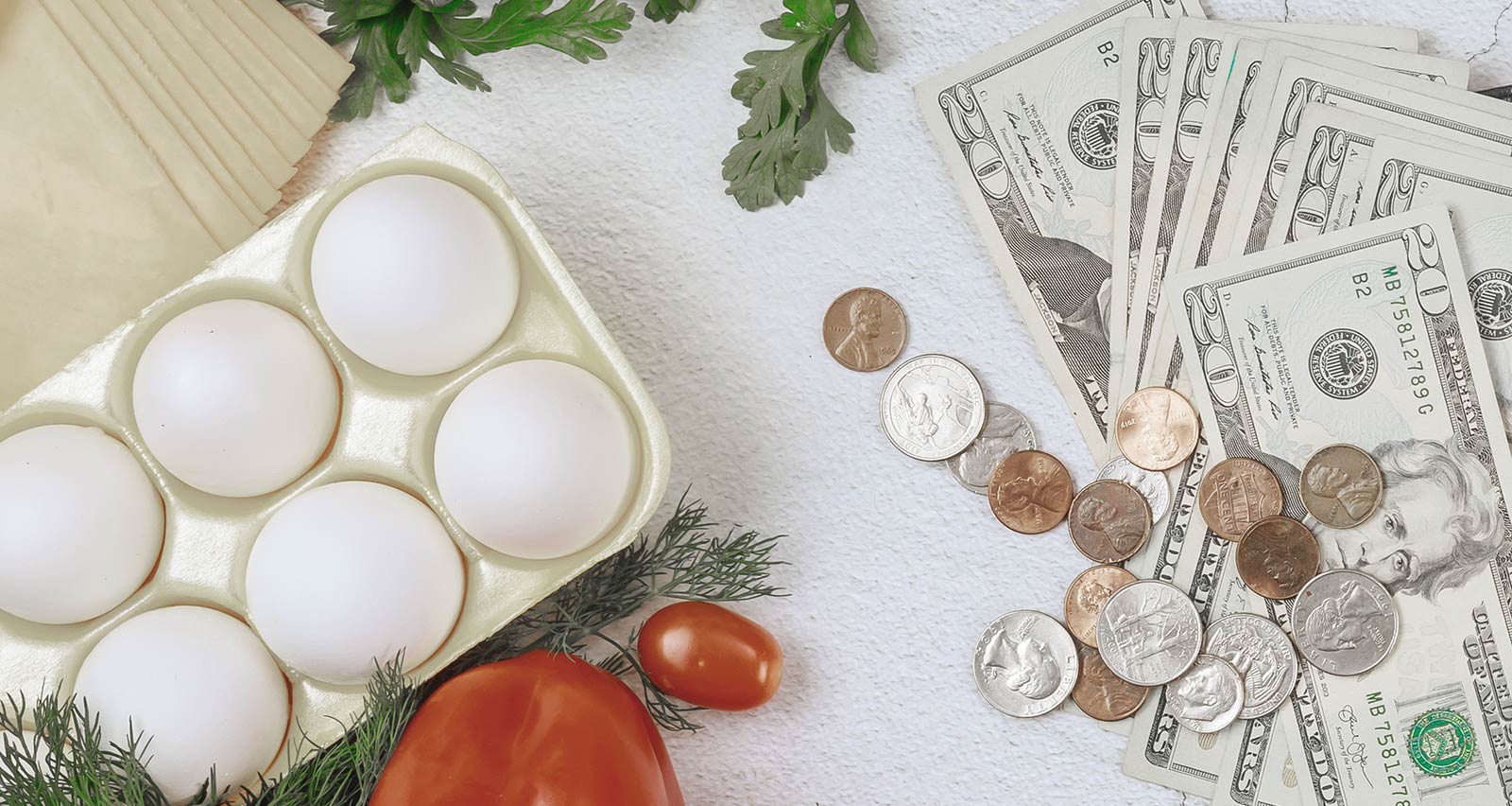 A table filled with fruits, vegetables and eggs surrounds an open wallet