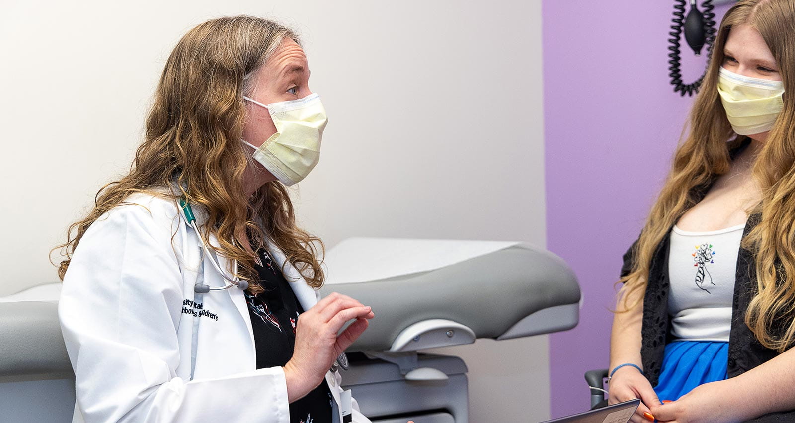 Amy Edwards, MD consults with a young patient