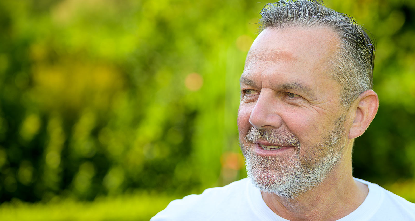 A mature man with short, gray hair and a well-groomed beard