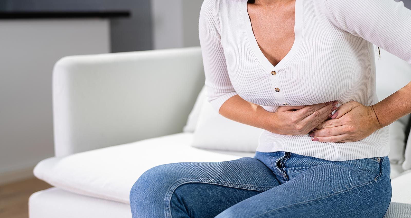 Woman clutching her midsection in pain