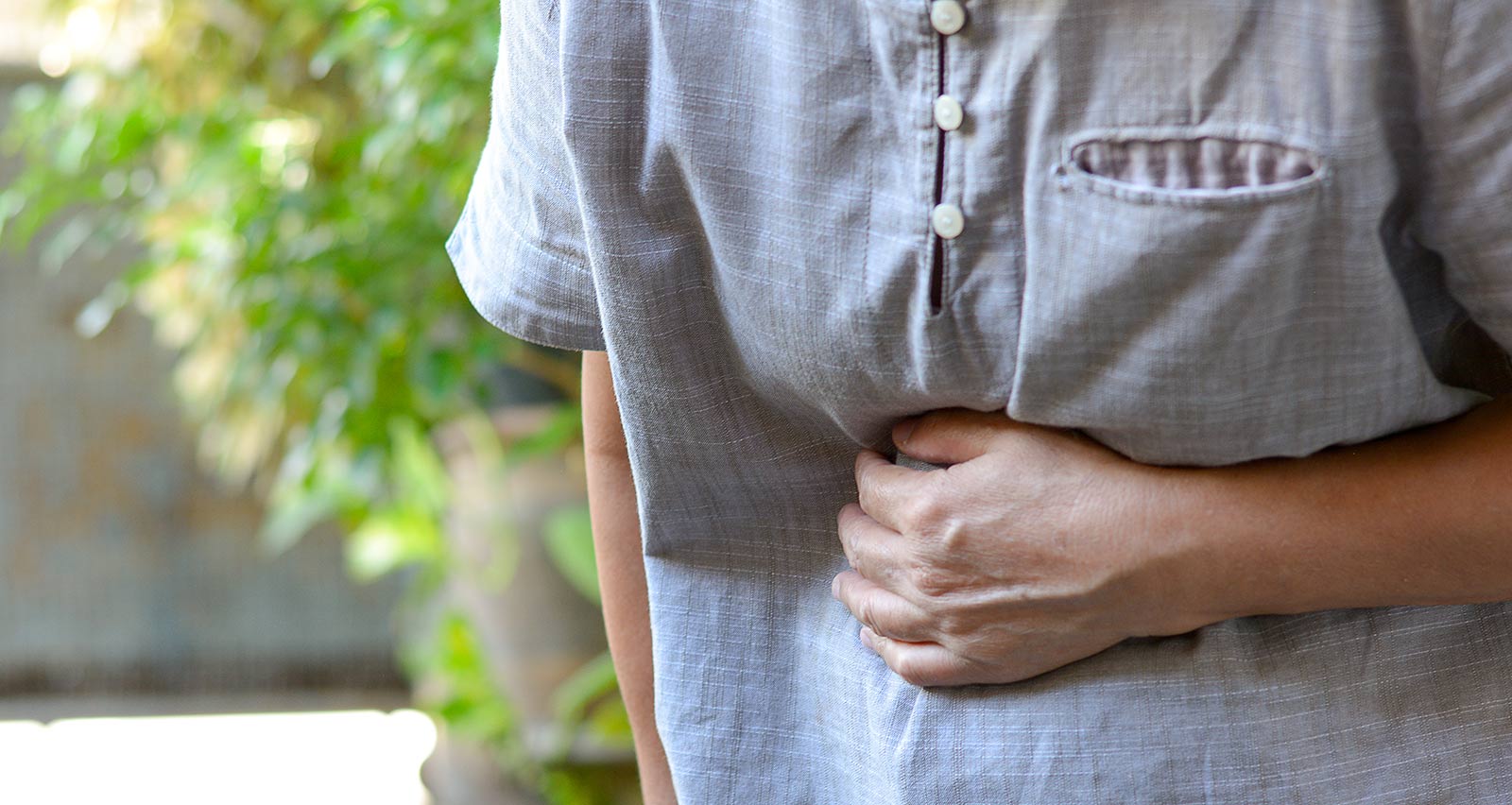 Older woman experiencing abdominal pain