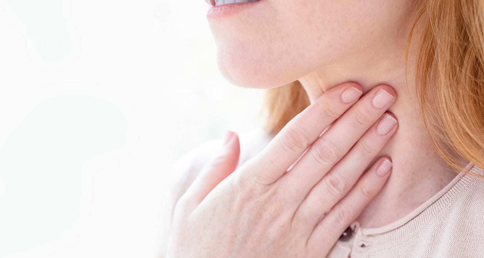 A woman experiencing difficulty swallowing