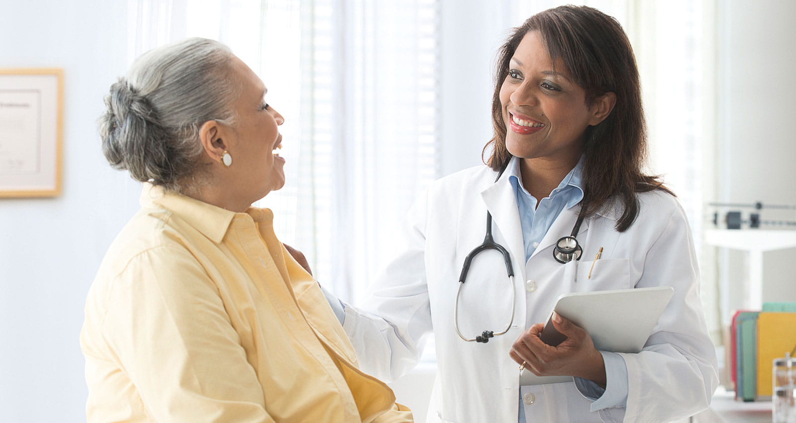 Woman talking to doctor in office