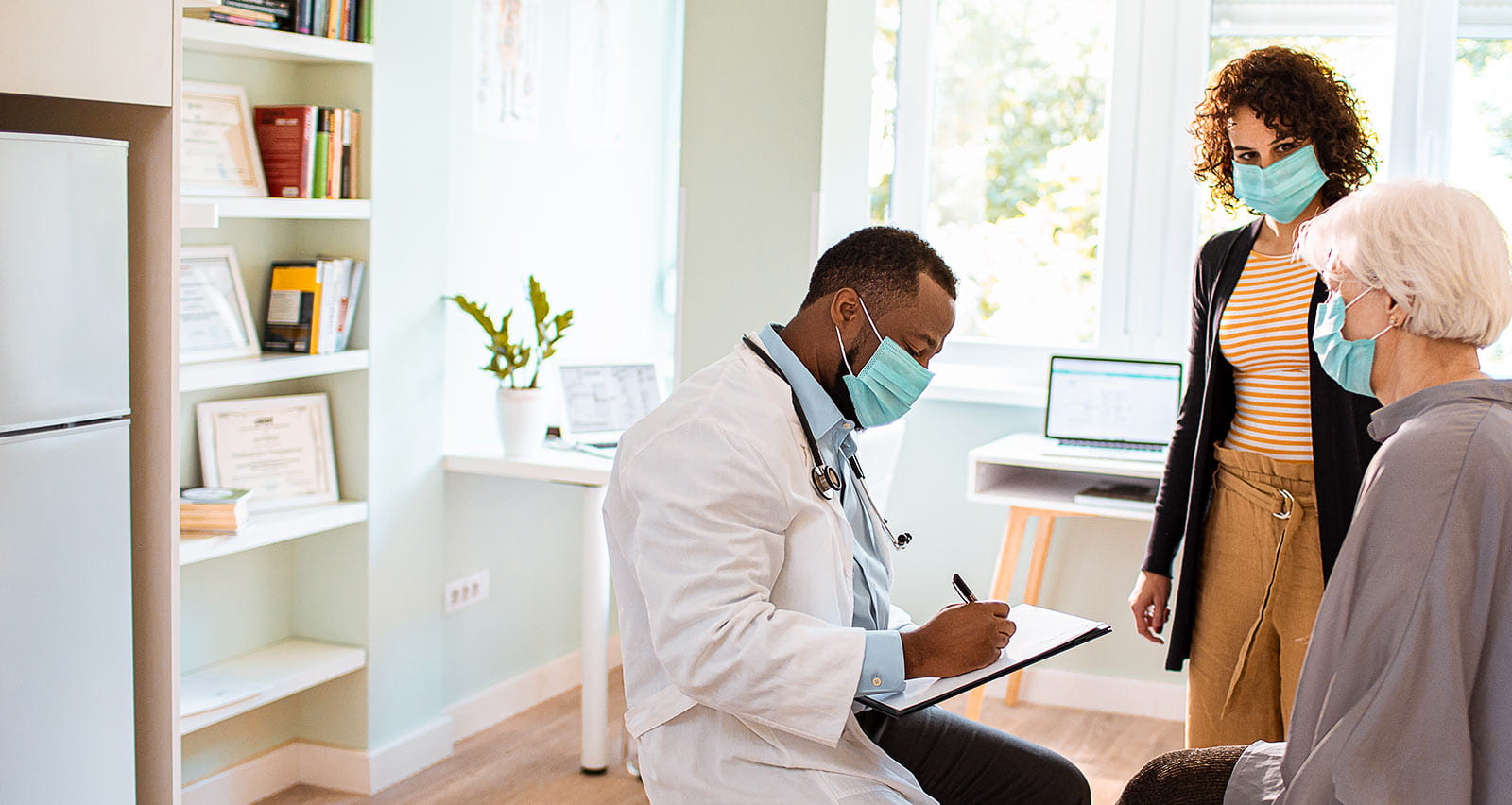 Close up of a senior woman and her daughter consulting with a physician