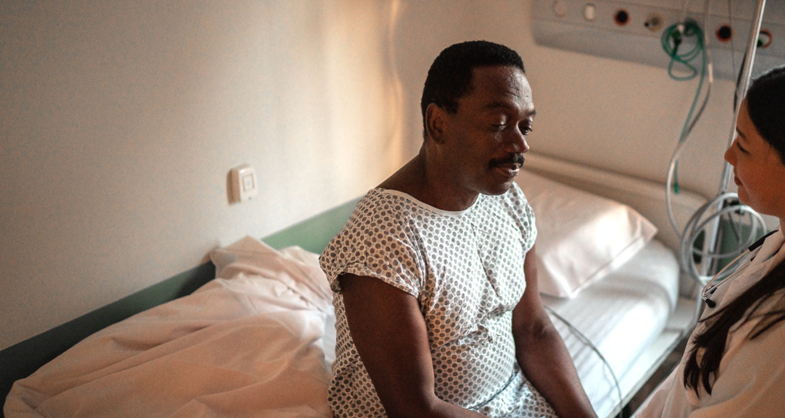 Man in hospital bed suffering from liver tumor