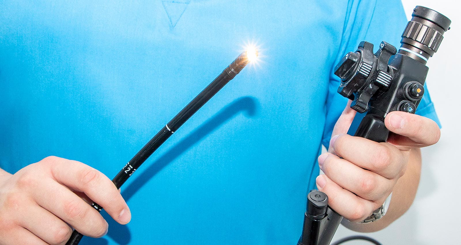 A doctor is holding an endoscope