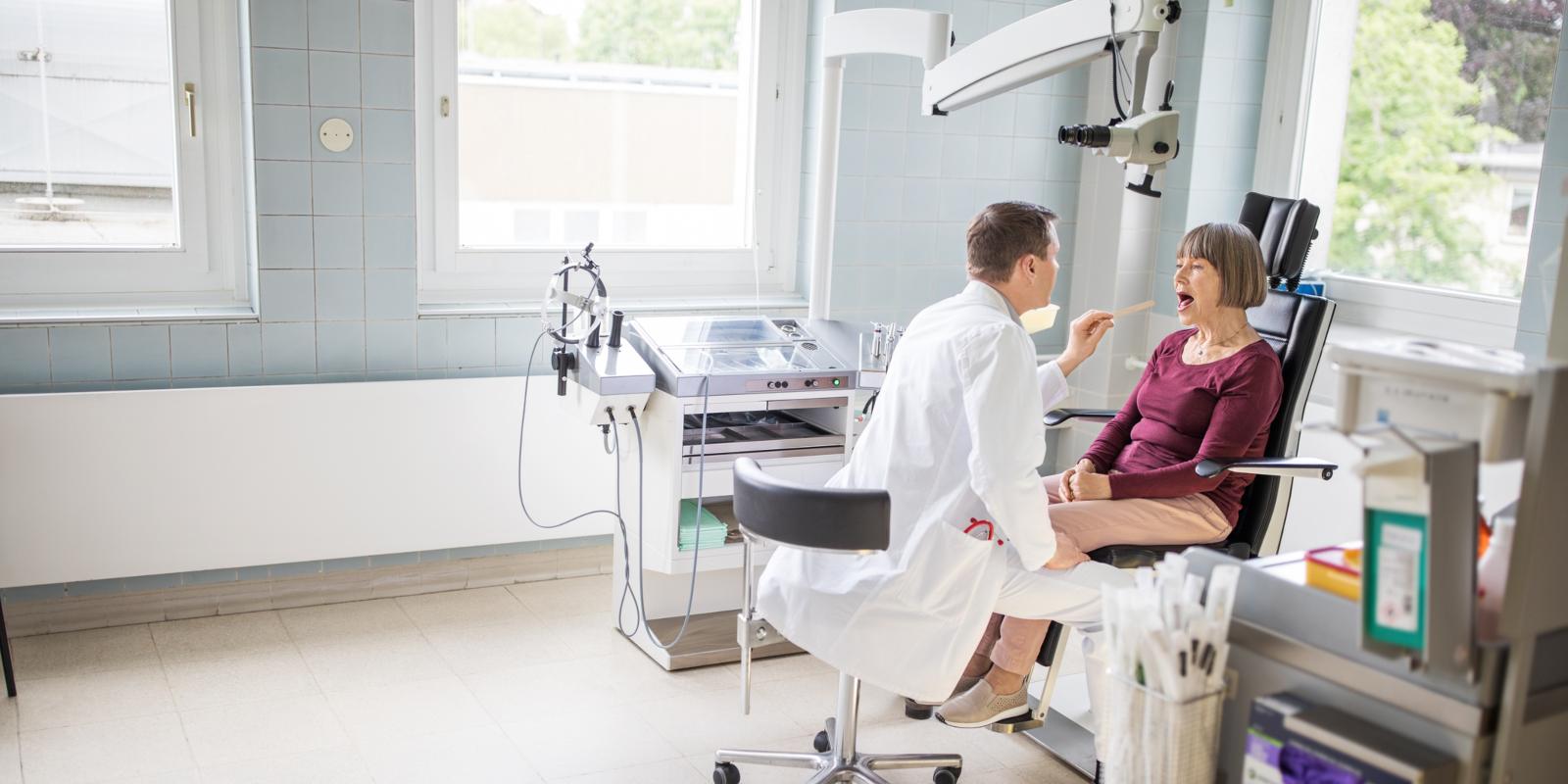 Ear, Nose and Throat provider examines woman in chair