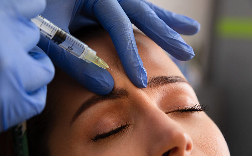 A young woman receiving a botox injection