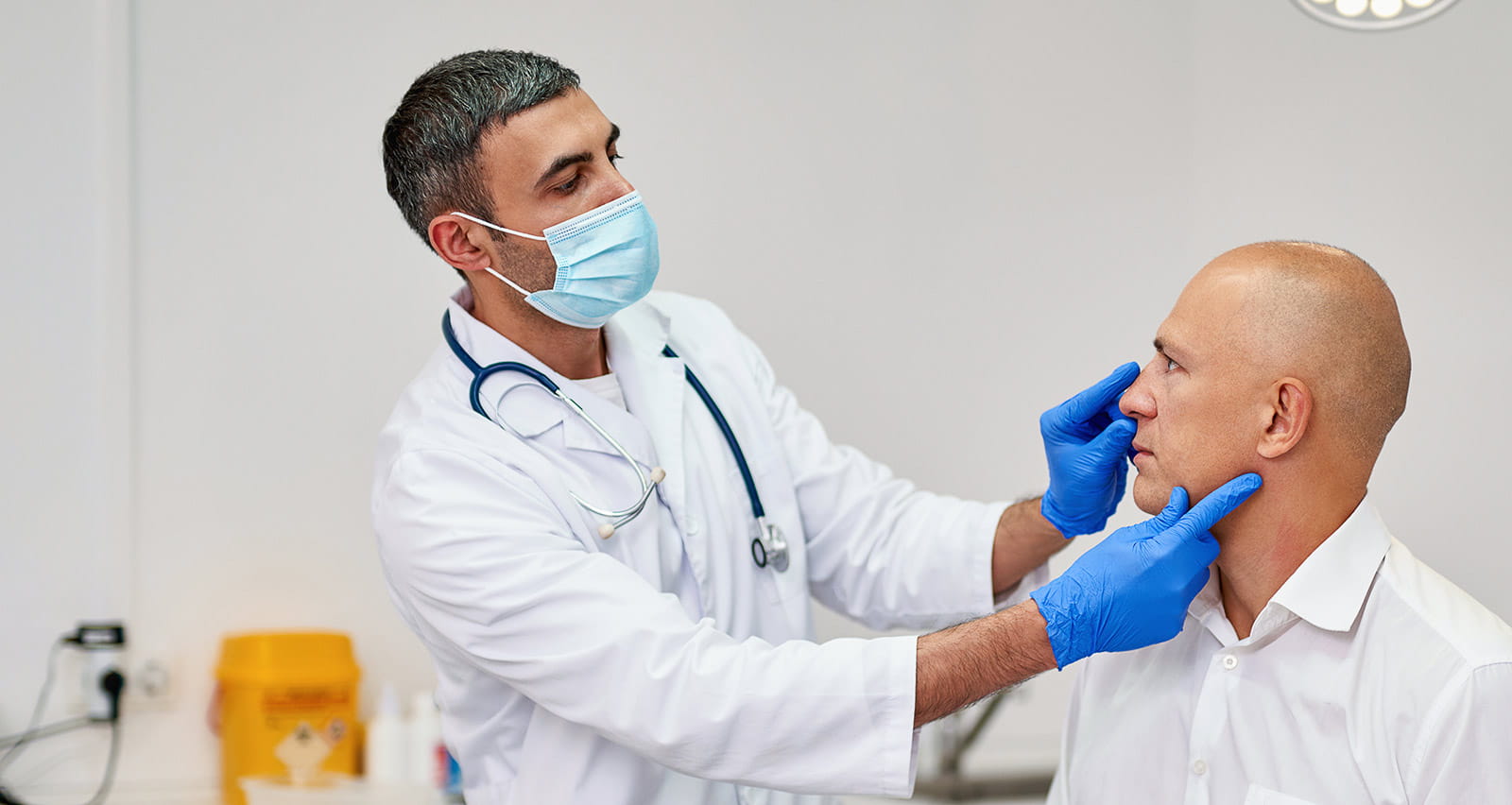 Man meeting with plastic surgeon before operation in clinic