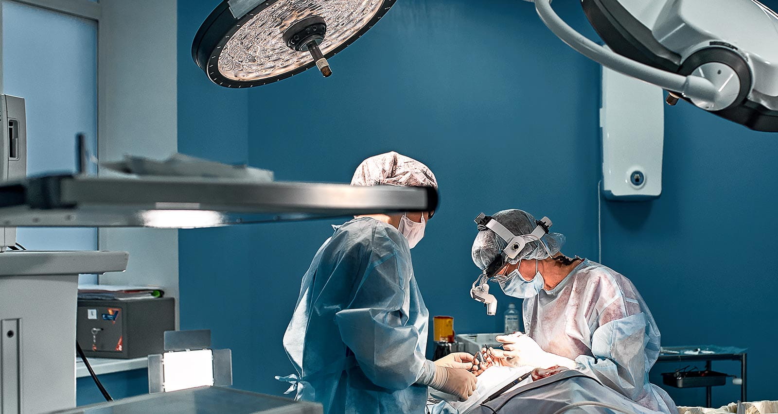 Two plastic surgerons performing an operation