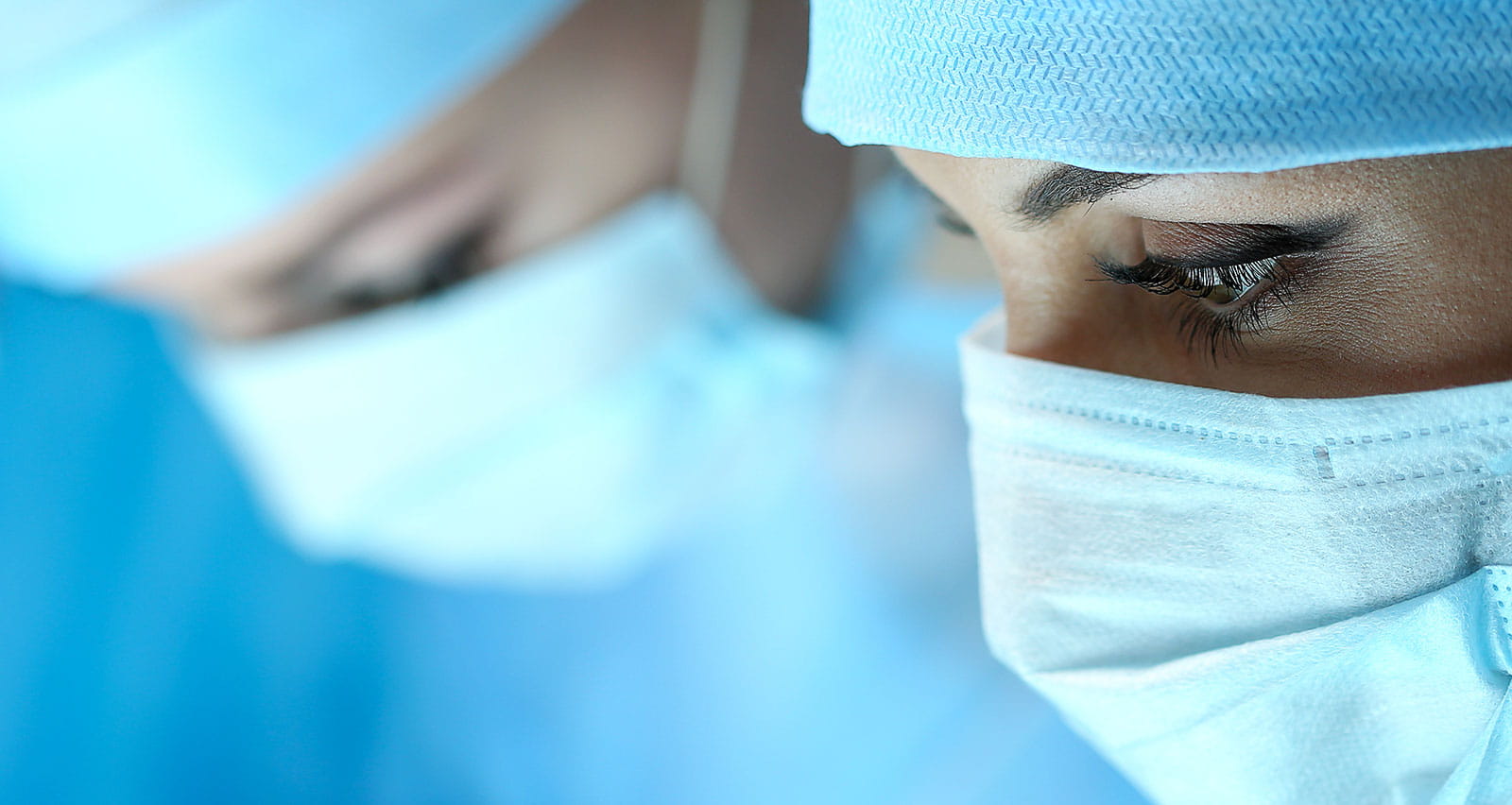 Surgeons at work operating in surgical theatre