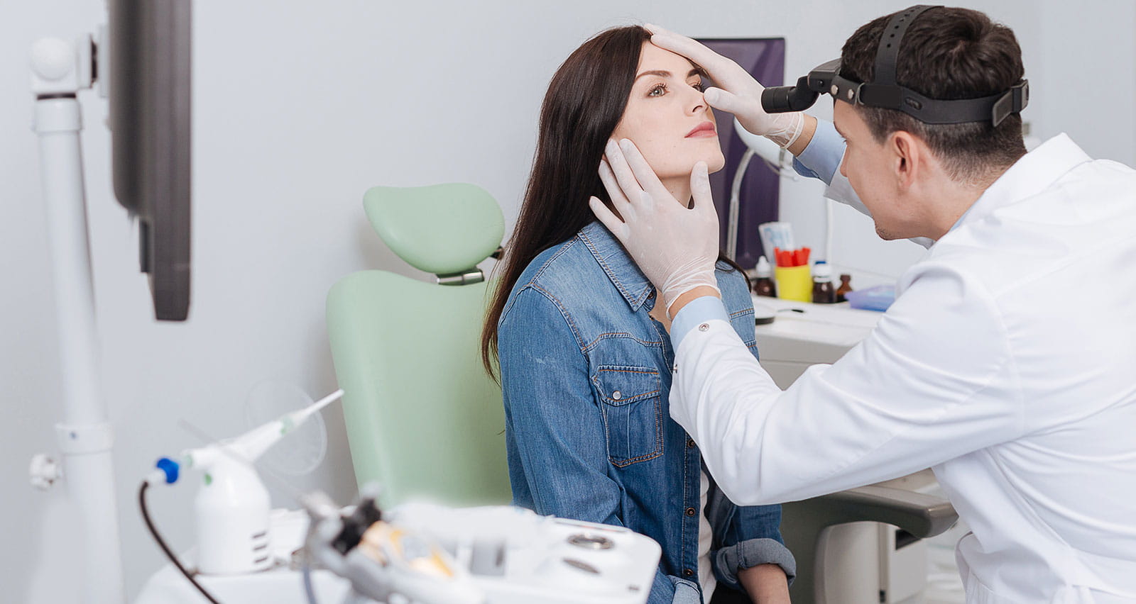 A female patient sitting in medical chair while being examined for a nasal airway procedure