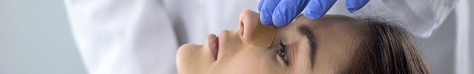 Doctor examining patient nose after nasal fracture