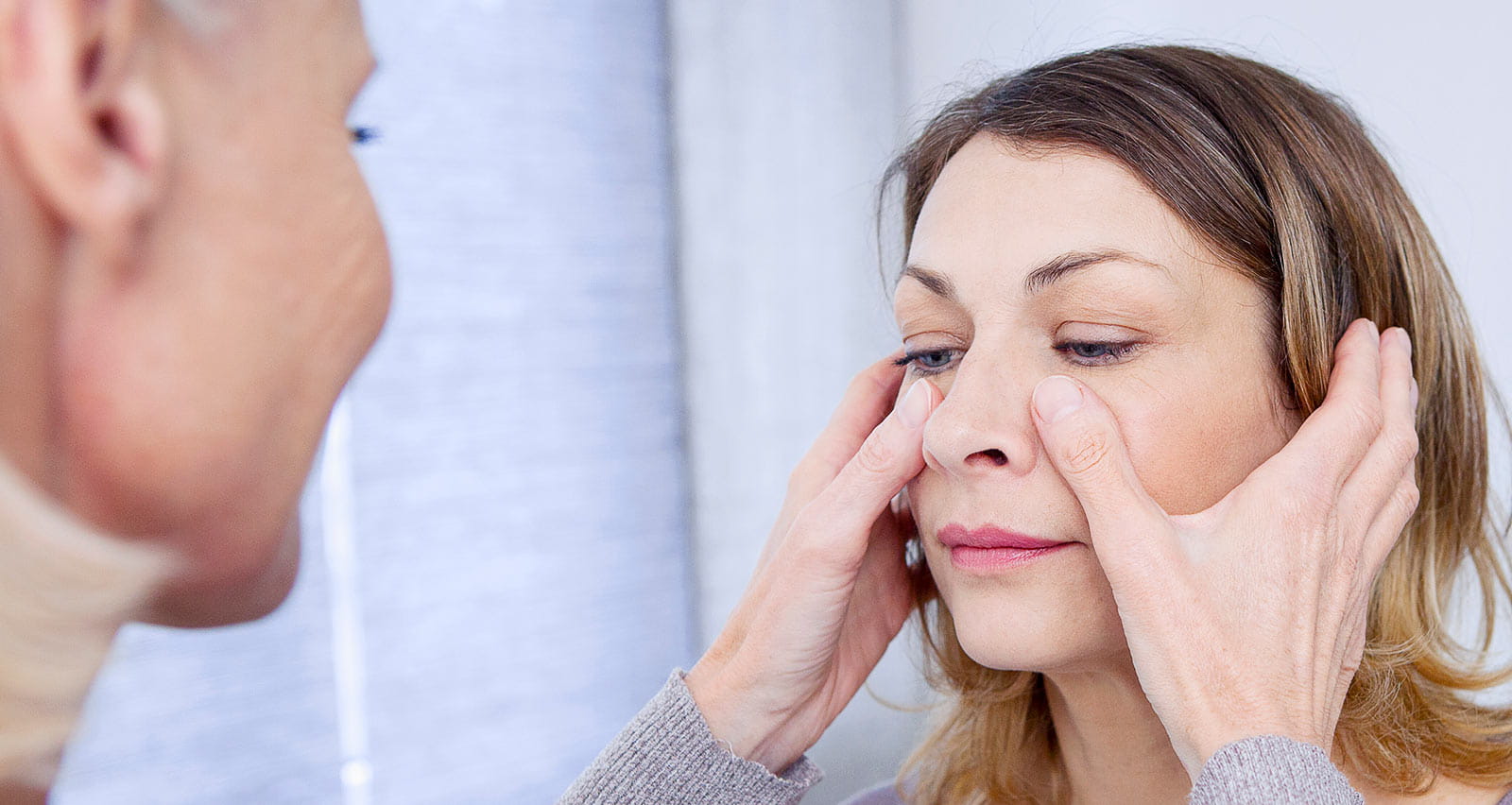 A doctor examining a patient’s sinuses