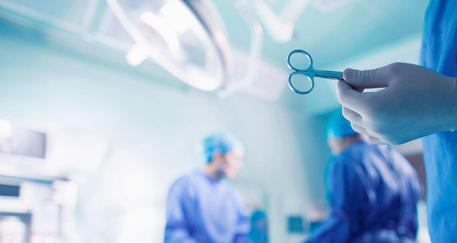 Doctors performing surgery in hospital operating room