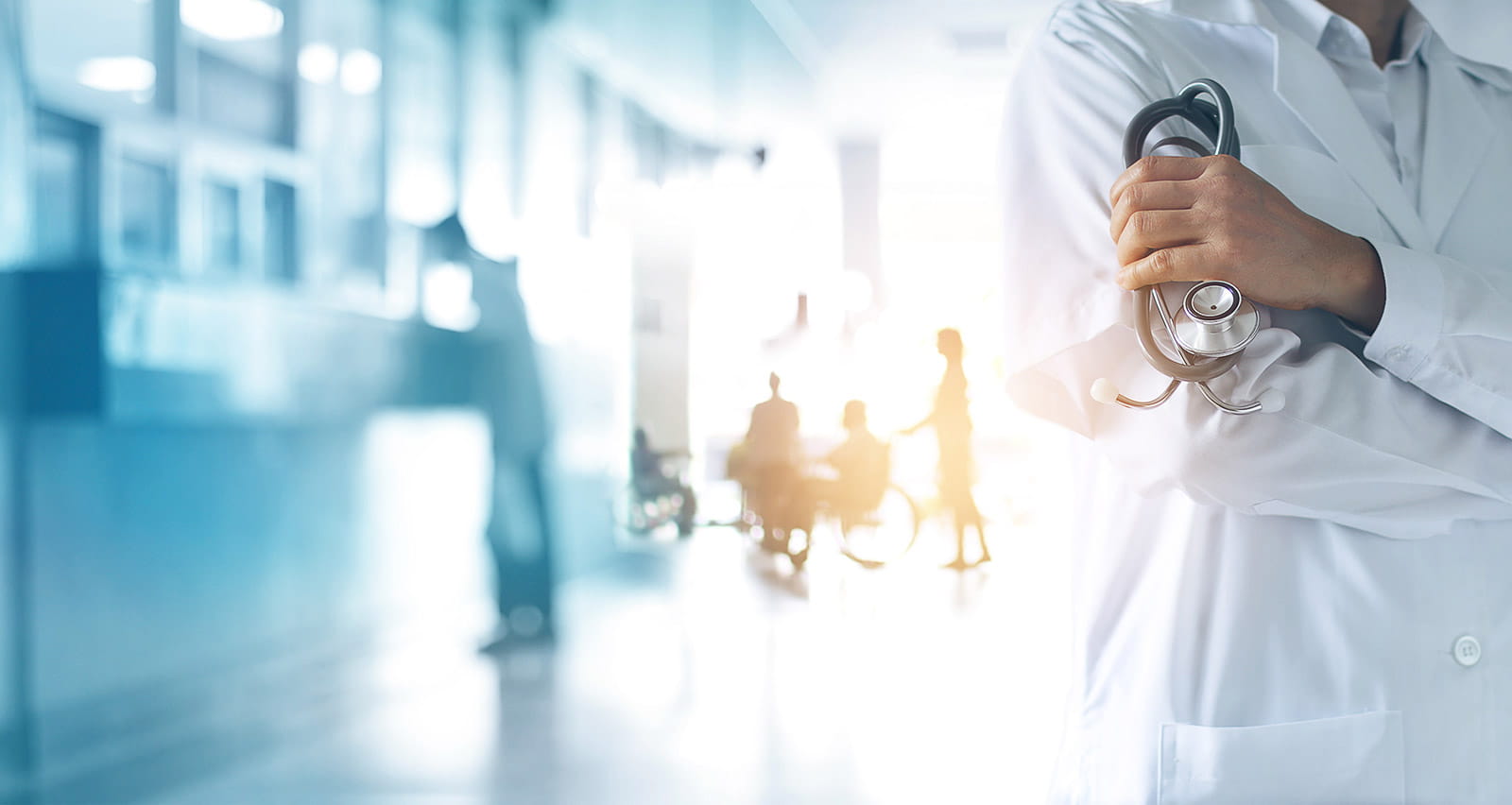 A doctor holding a stethoscope as patients are admitted to the hospital 