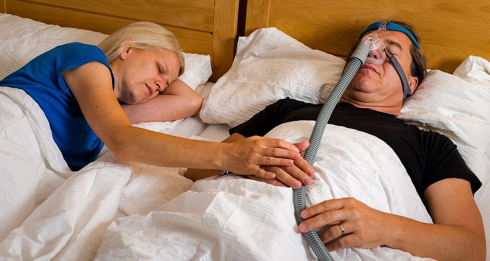 A man using a CPAP machine to stop choking and snoring from obstructive sleep apnea