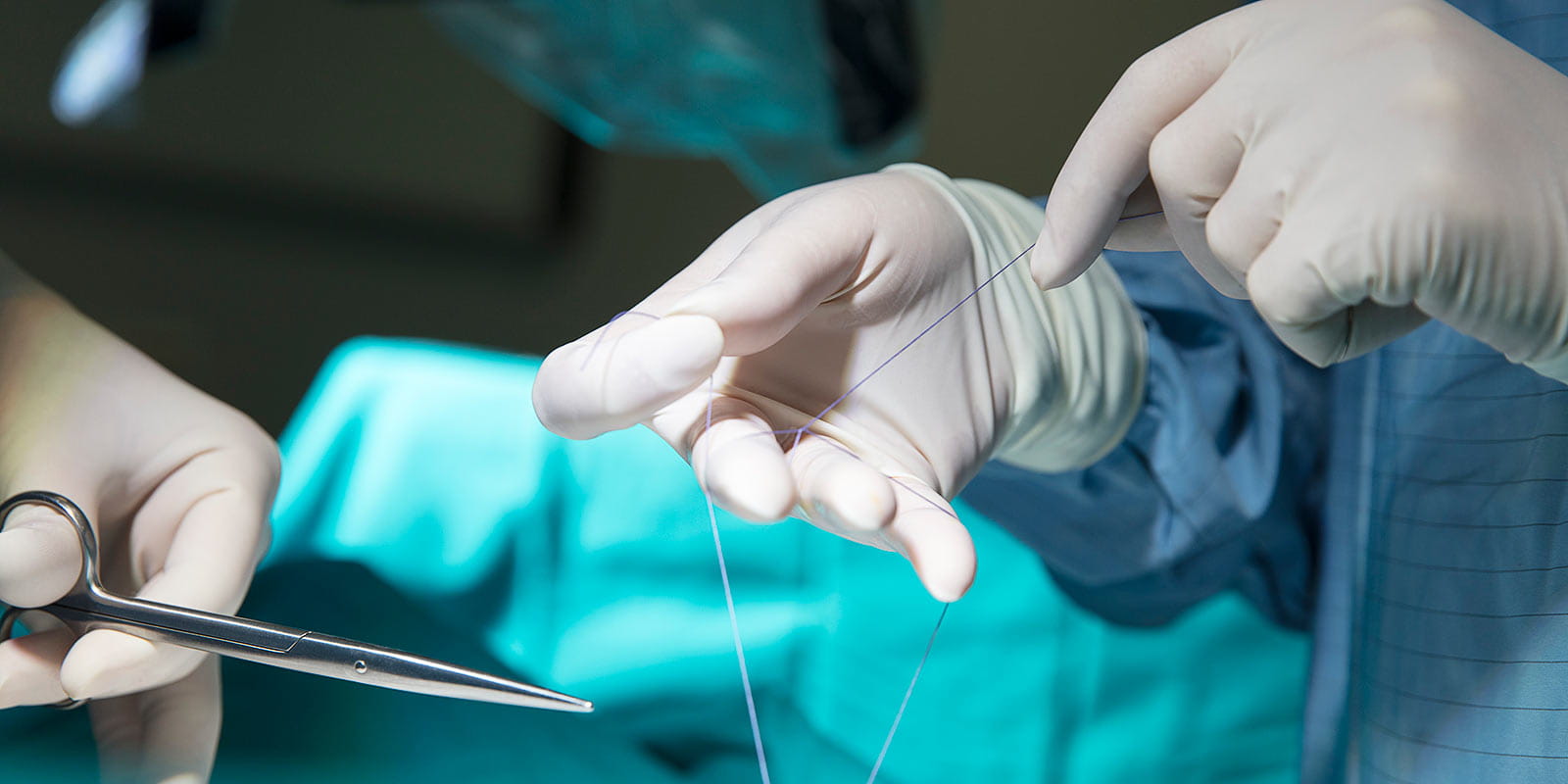 Ear, Nose and Throat Surgeon closing a stitch