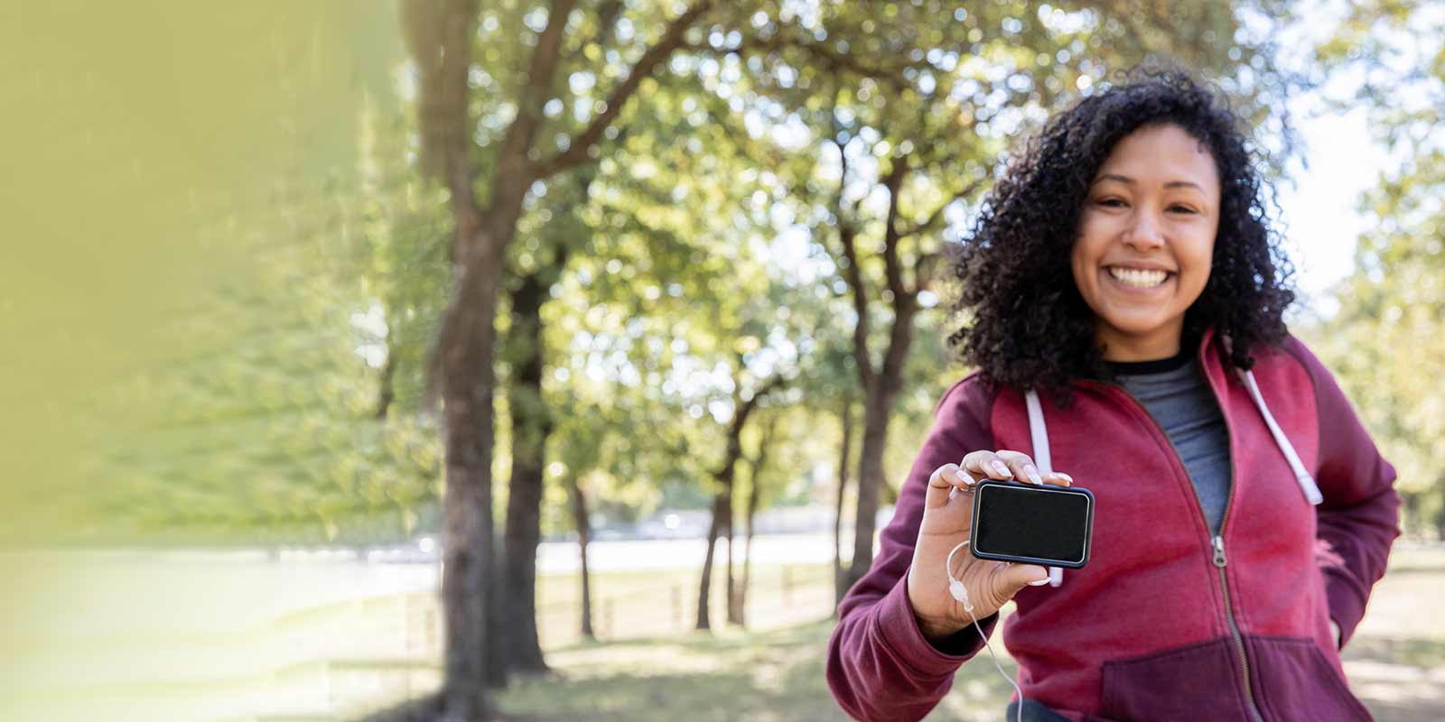 Active woman with Type 1 diabetes holds blood sugar monitor