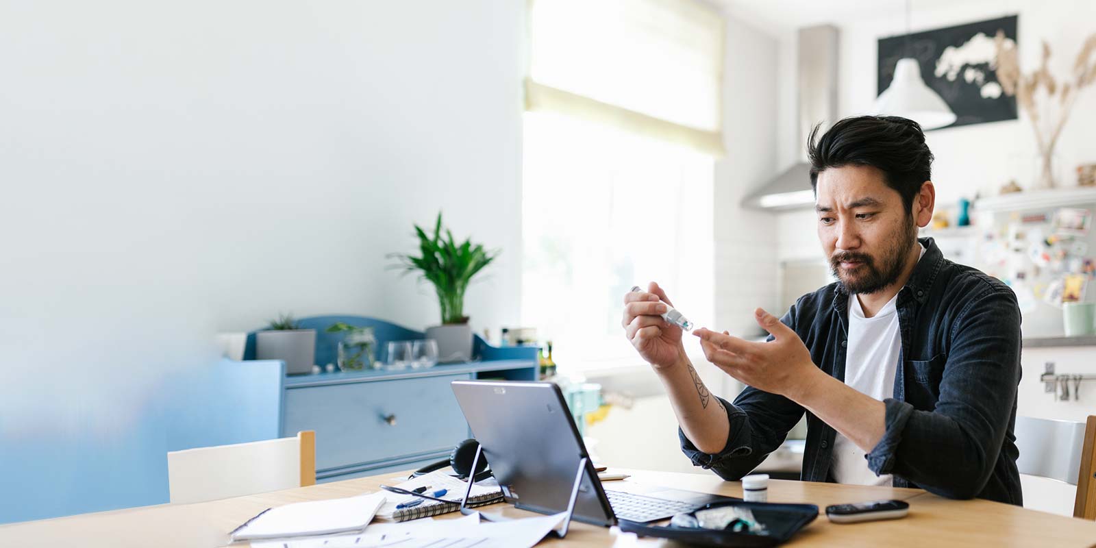 Asian man checking blood sugar