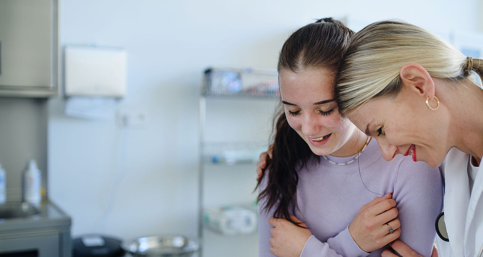 A female doctor explaining diagnosis to teenage girl in her office