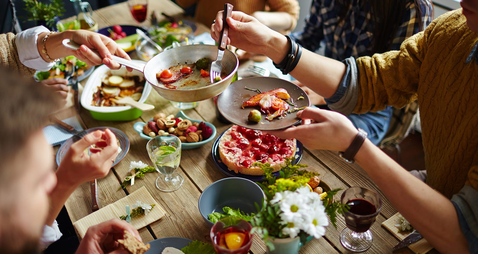Image of people gathered at table sharing a healthier meal