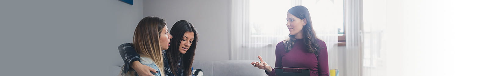 Young lesbian couple on counseling appointment, talking about their problems with therapist