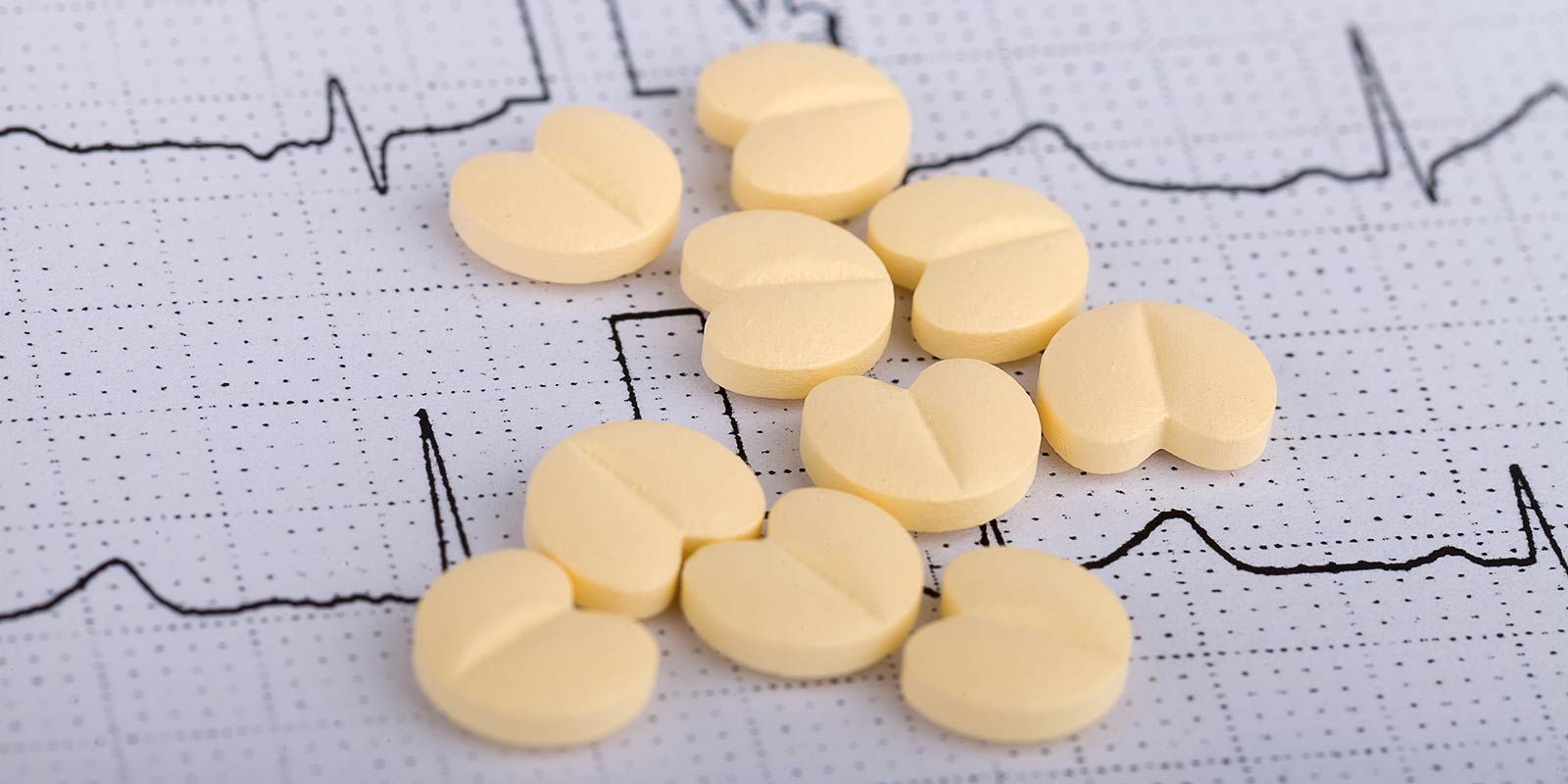 Heart-shaped pills spread across ECG printout