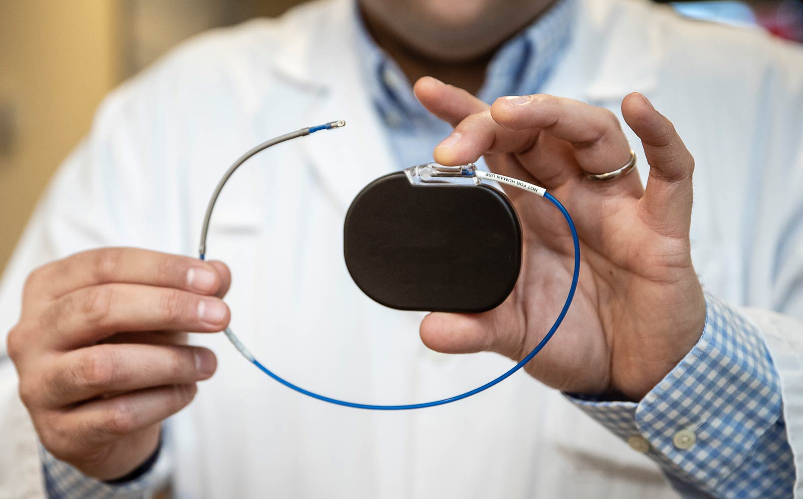 A doctor shows a pacemaker