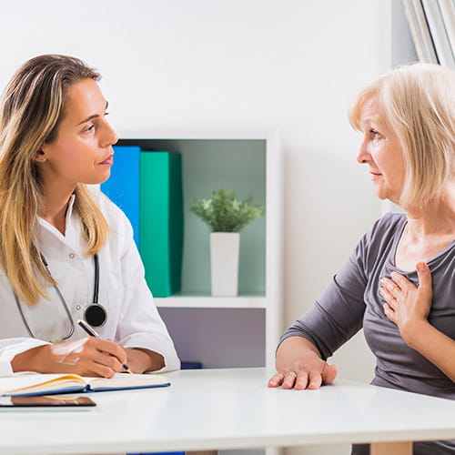An older female patient consults with an electrophysiologist