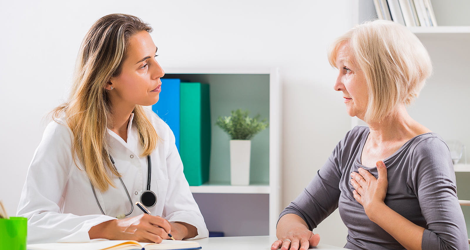 An older female patient consults with an electrophysiologist