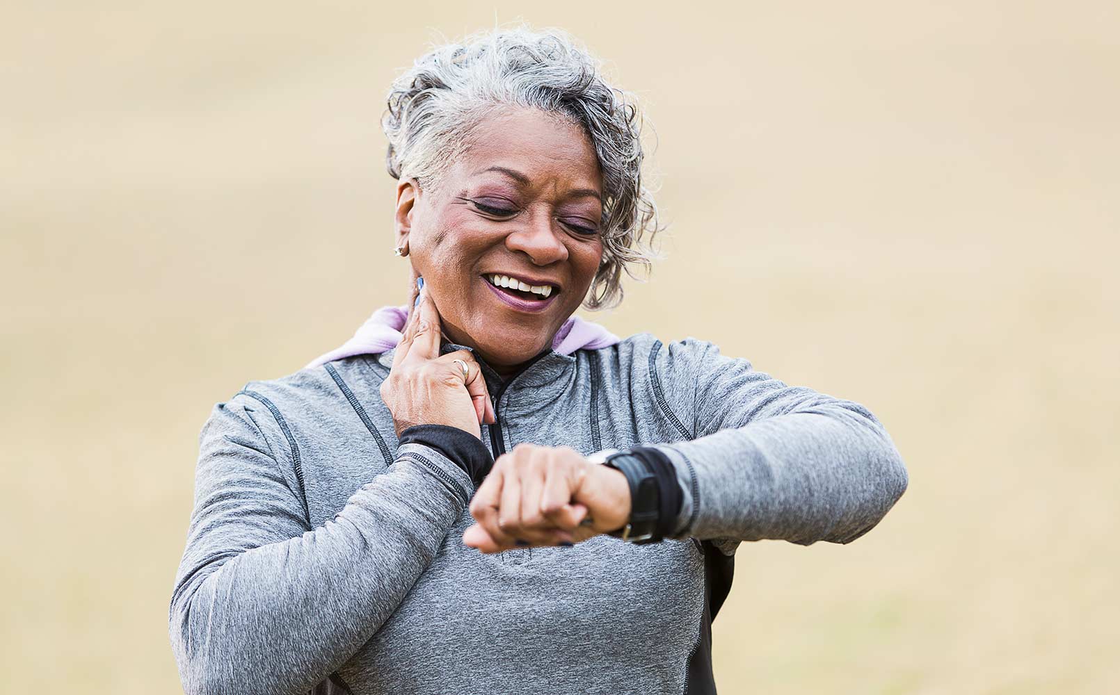 An African American senior woman is checking her pulse to see if her exercise has increased her heart rate