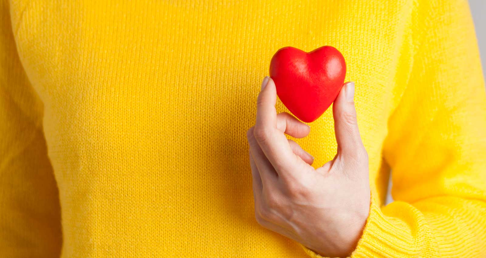 Adult woman holding red heart